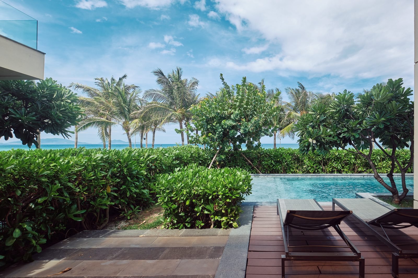 Private pool of a Beachfront Villa looking toward the ocean and palms